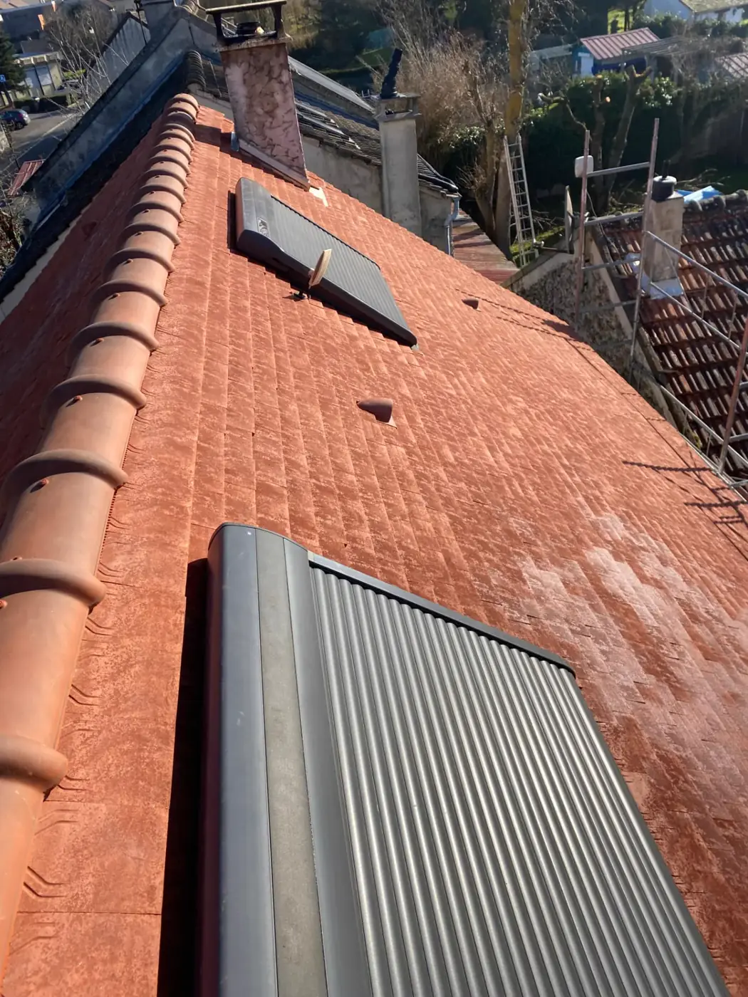 Versant de toiture rénové en tuiles plates terre cuite avec deux fenêtres de toit à Magny-le-Hongre